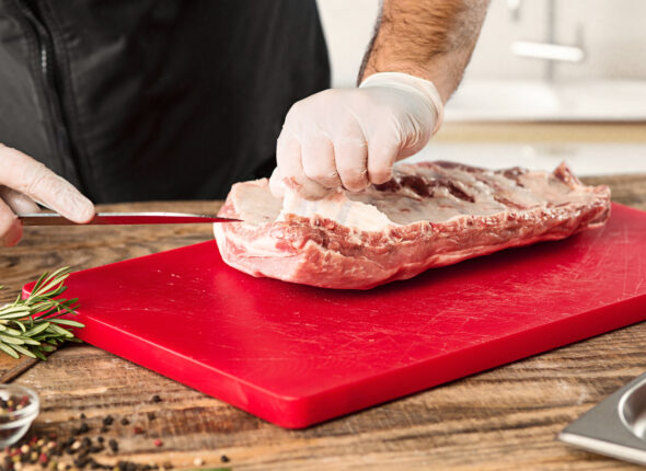 Man cooking meat steak on kitchen
