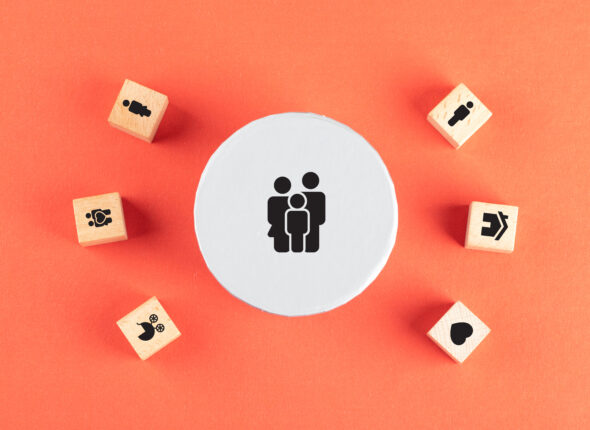 Family concept with icons on wooden cubes on red background flat lay.