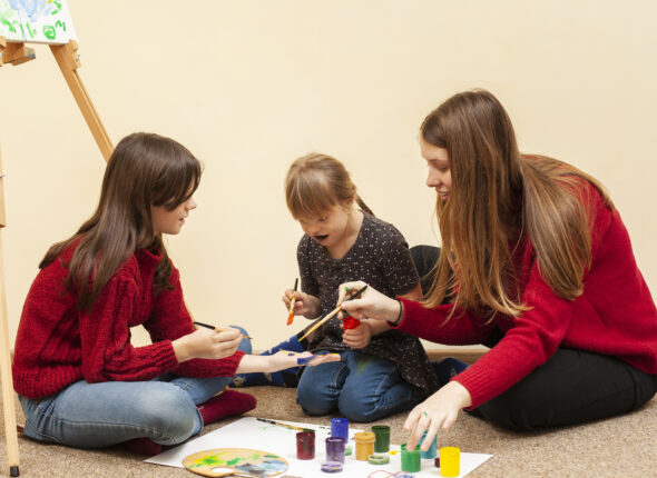 girl-with-down-syndrome-painting-with-colors