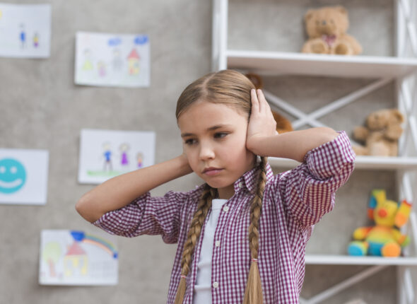 portrait-sad-girl-covering-her-ears-with-two-hands